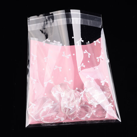 Cellofaan zakje roze met witte strikjes 1
